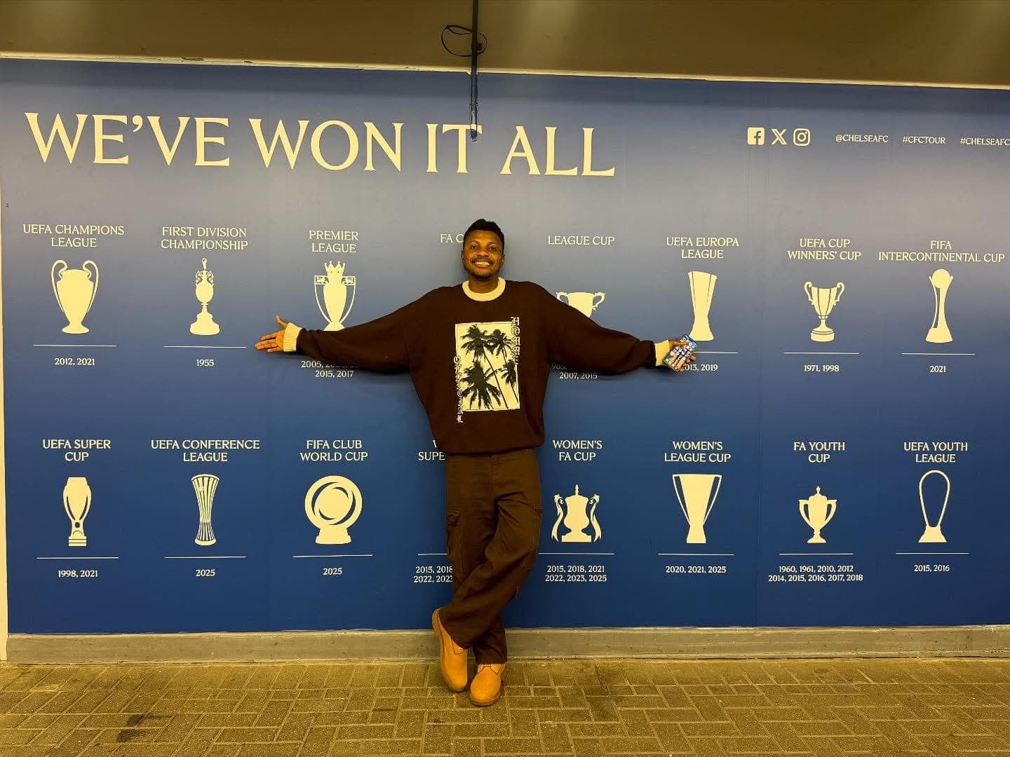 Philip Akinjobi standing in front of a trophy wall