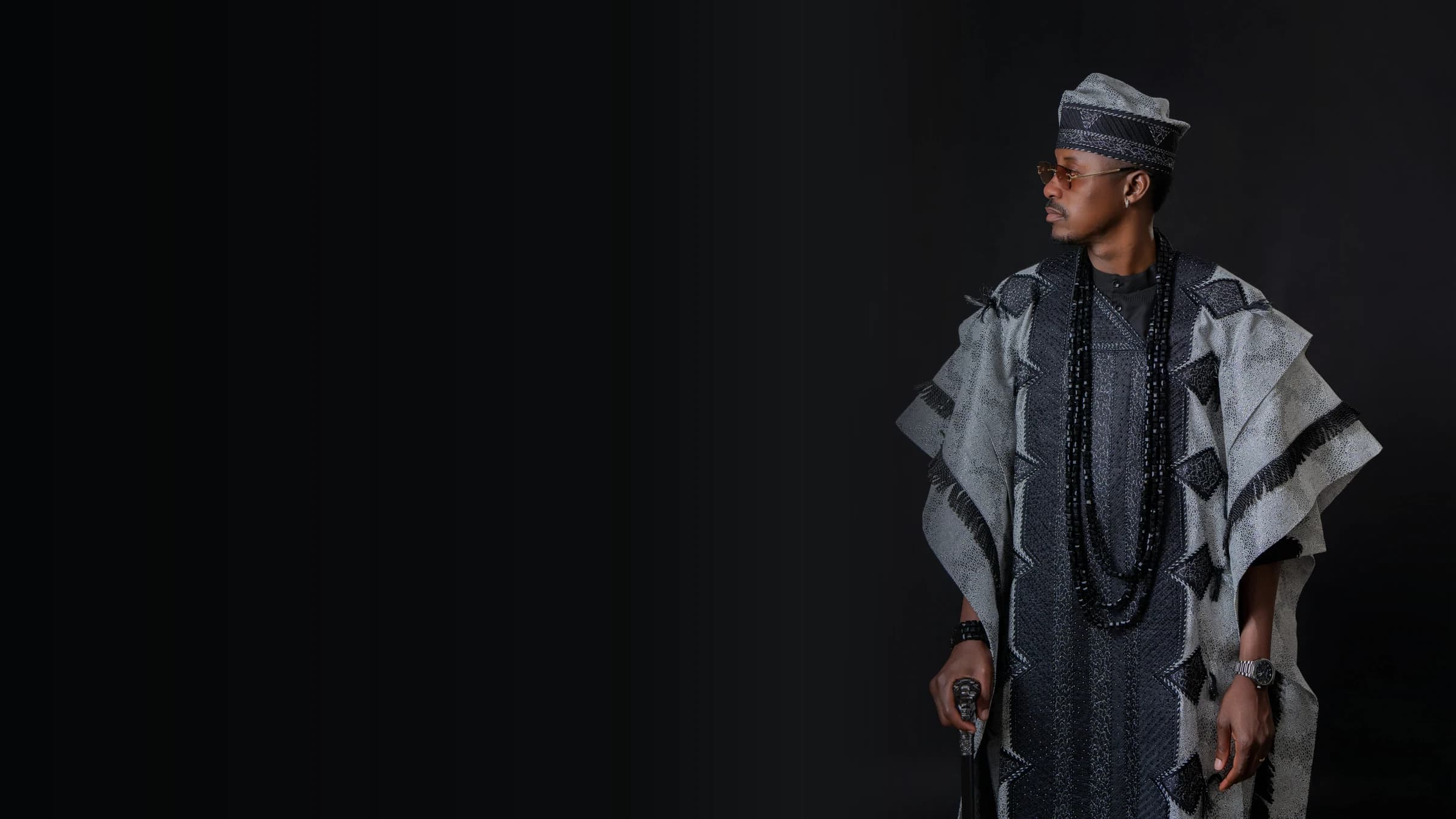 Philip Akinjobi in black-and-silver Yoruba attire for his 40th birthday portrait